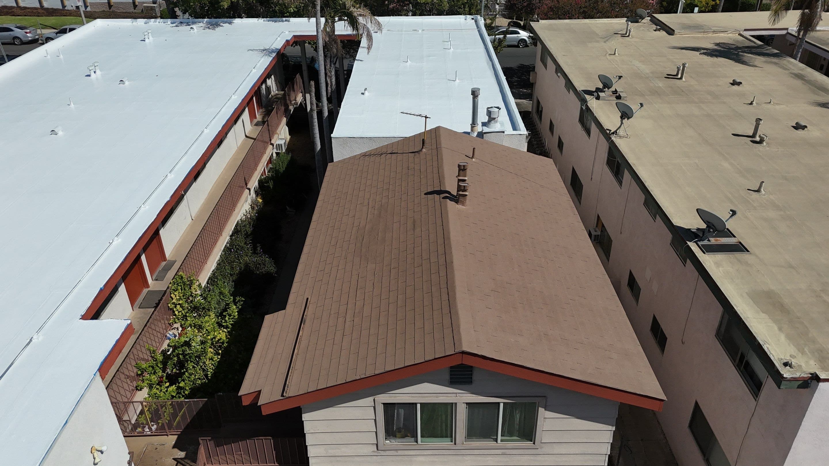 Aerial view of both buildings with their roofs finished white.