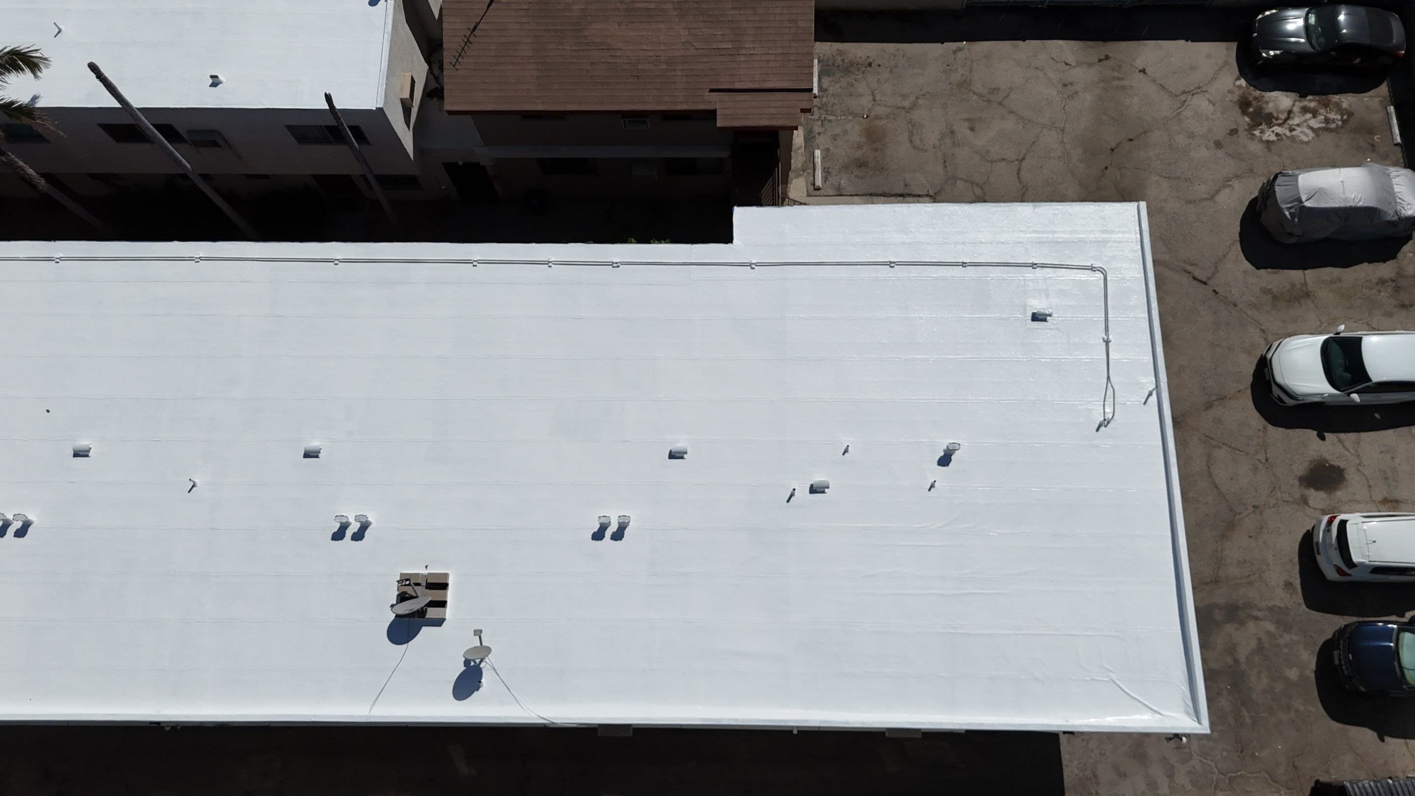 The same view over the parking lot, with the flat roof finished white.