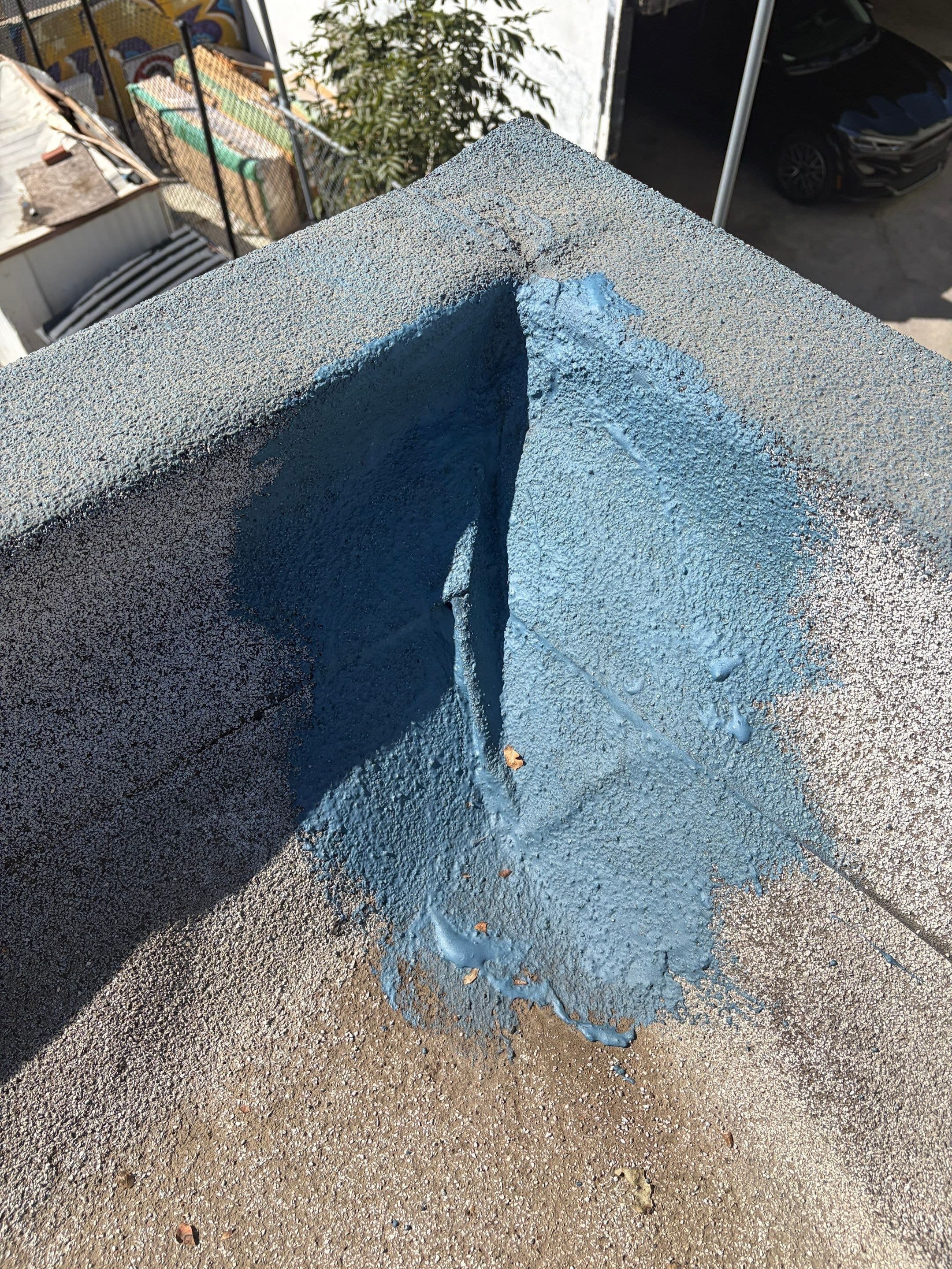 Reinforcement fabric worked into an inside corner at the parapet.