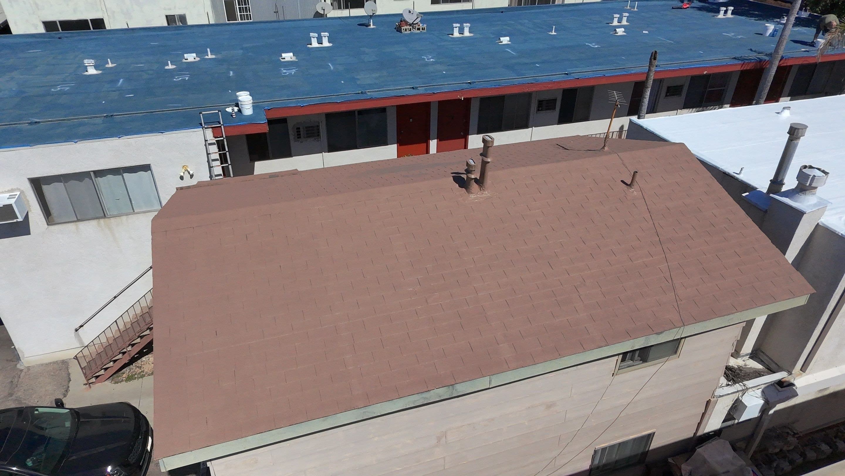 Aerial view of the detached building after its shingle roof was coated white.