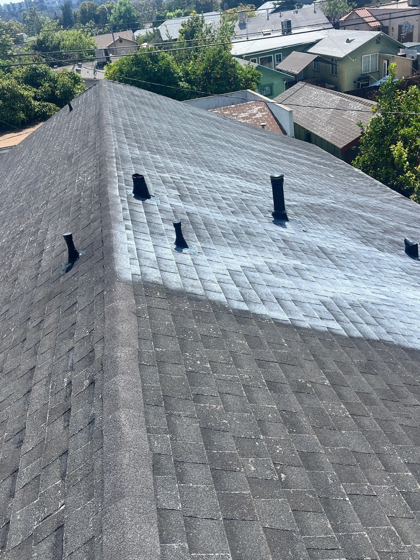 A technician working the slope of a roof in Atwater Village, Los Angeles.